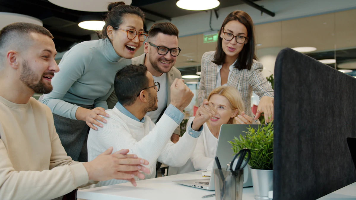 A happy team celebrating together at an office desk